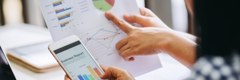 Close up of people looking at graphs