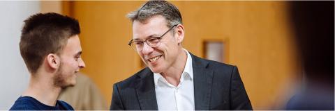 member of staff having a discussion with a student