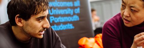 male (Turkish) and female students talking at global cafe