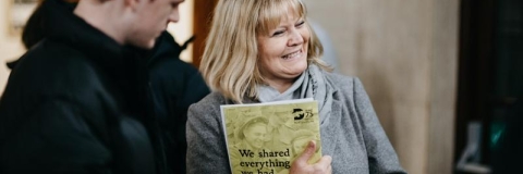 Parent and young person attending an event smiling