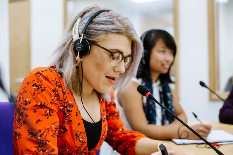 Person speaking into a microphone
