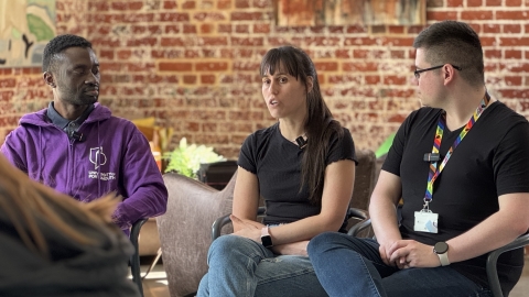 Three students sat in a line forming the PGR alumni panel, answering questions