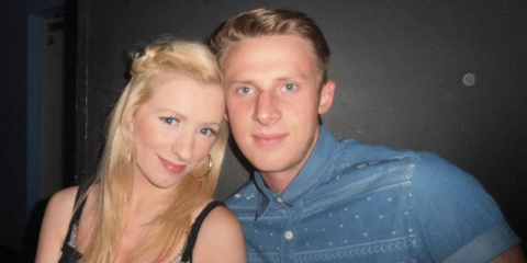 University of Portsmouth graduates, Mark and Charley at a club during their student days smiling to camera