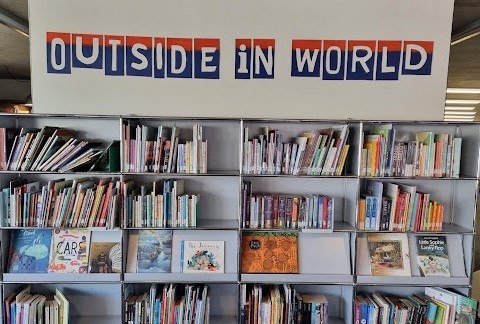 Display of books with the heading Outside in World