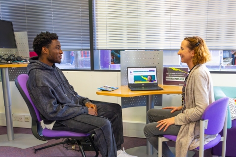 A student speaking to a careers adviser