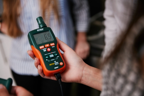 Close up of hand holding moisture meter