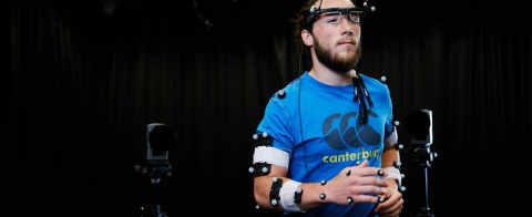 Man running on a treadmill with motion sensors on his body