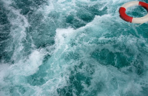 Choppy waters with floating life ring buoy