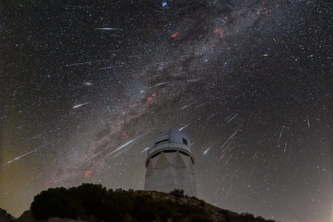 DESI observes the sky from the Mayall Telescope, shown here during the 2023 Geminid meteor shower. 