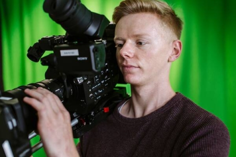 A man holding a Sony camcorder