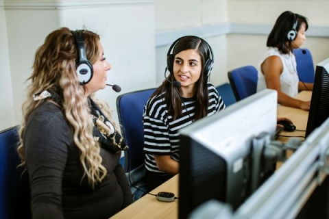 students using computers and headsets