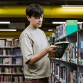 Student reading a book in the University Library 