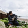 Palaeontology students Hamzah Imran on Southsea beach by the old seawall