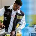 Student pouring tea in university student accommodation kitchen