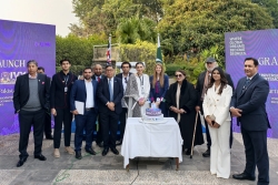 University of Portsmouth representatives pose with Ivy Academic Network representatives in front of a cake to celebrate partnership