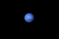 Image shows a blue planet within deep, dark space. Image is a representation of the Universe