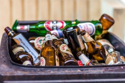A bin filled with glass bottles