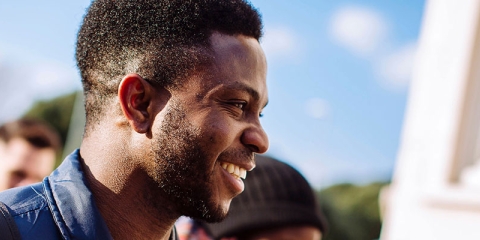 A group of students smiling by Rees hall