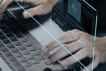 Hands over a laptop keyboard