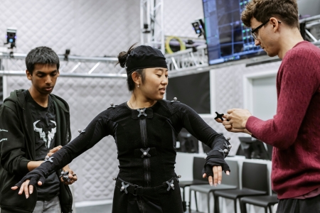 Staff member assisting student with motion capture suit.
B Roll Day 3