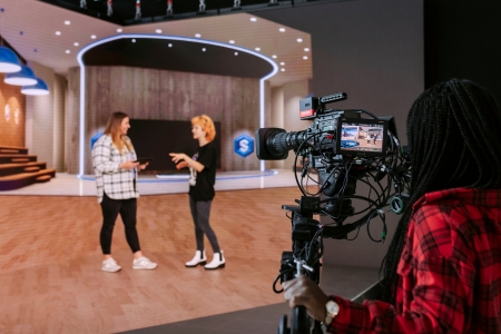 Three Students utilizing the CCI Future Technologies Virtual TV Studio