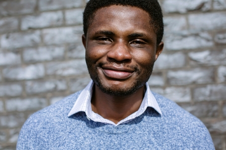 Headshot of Male student in blue pull over stood outside of building with field 
NOT FOR THIRD PARTY - CONSENT