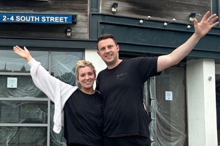 Mark and Charly standing outside their new restaurant before it was renovated
