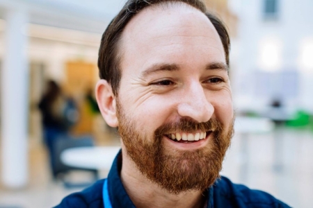 A man with a beard, smiling